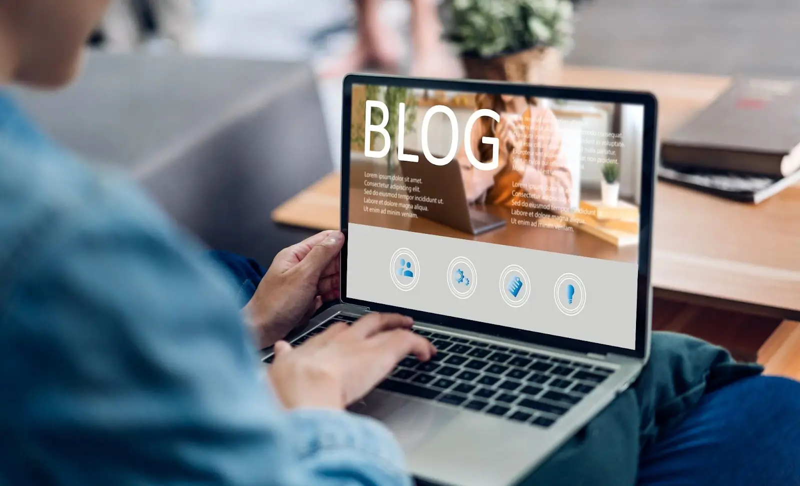 A person typing on a laptop, creating a blog post.