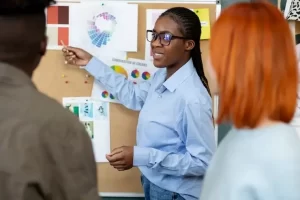 A lady presenting to her colleagues at work.