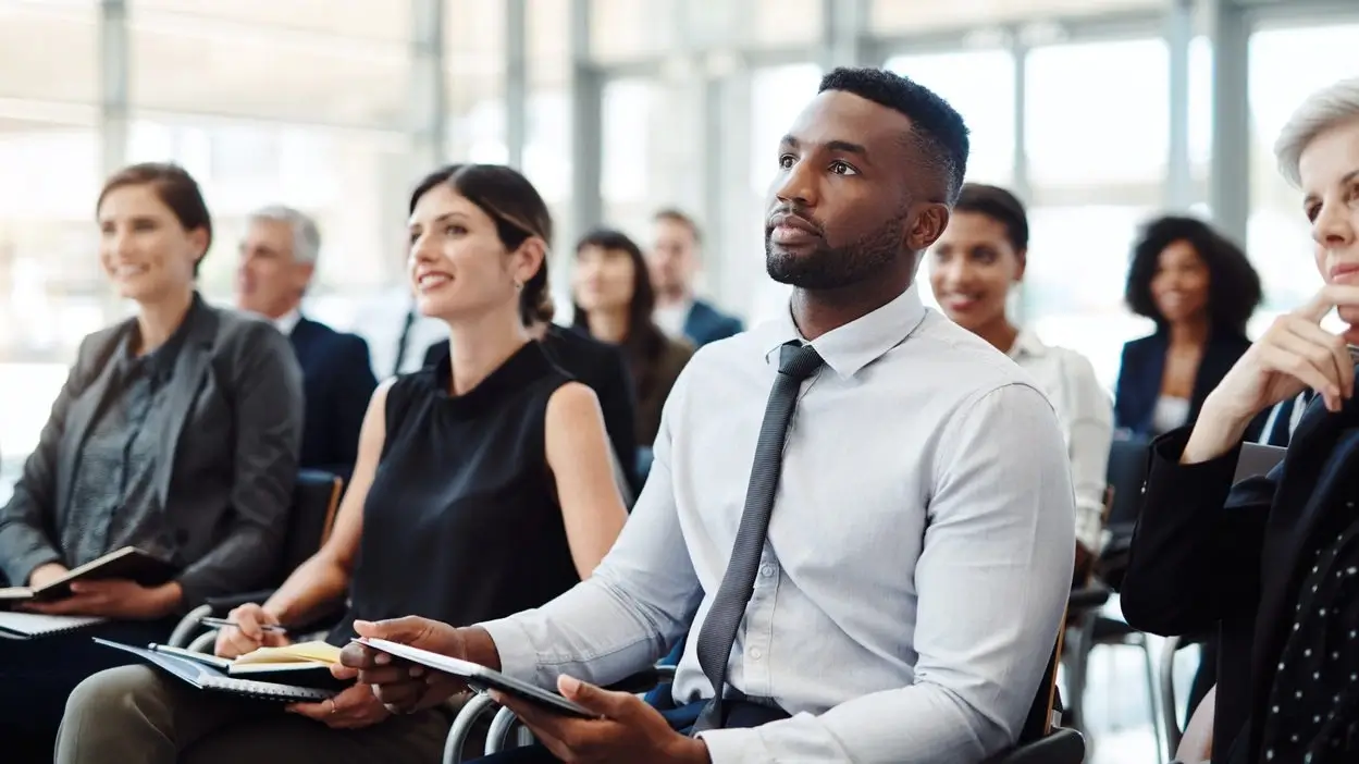 Group of people listening attentively during a career program.