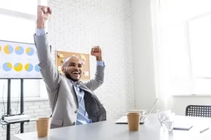 A cheerful and refined man in a corporate environment.